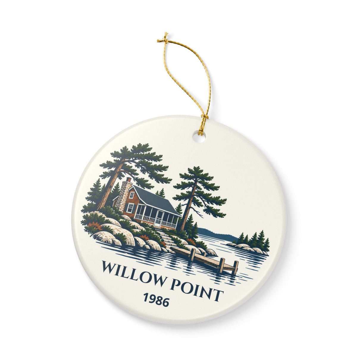 Angled front view of the lake-house ceramic ornament and gold-colored string.
