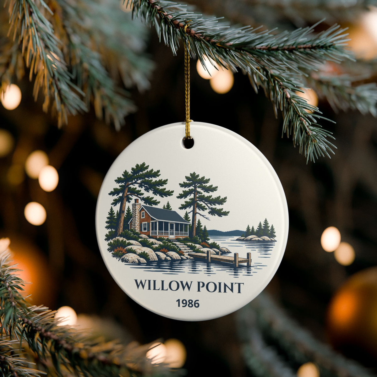Personalized lake-house ornament hanging on a Christmas tree; example name and year shown.
