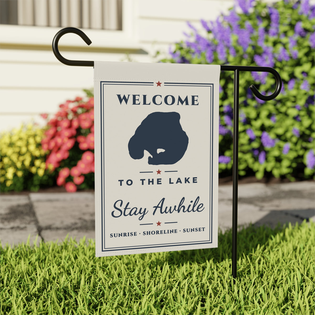 Welcome to the Lake garden flag displayed in grass near a porch and flowers; stand not included.