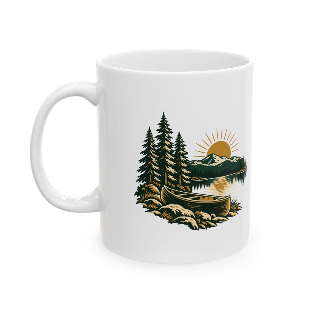 White ceramic mug with handle on the left, printed with a canoe, pine trees, lake and golden sun.