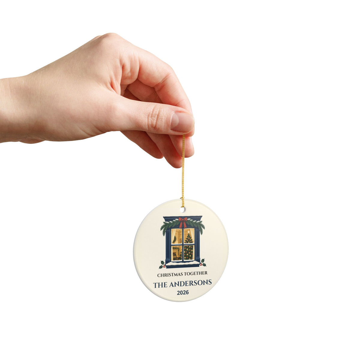 Hand holding the family Christmas ornament by its string to show its scale.